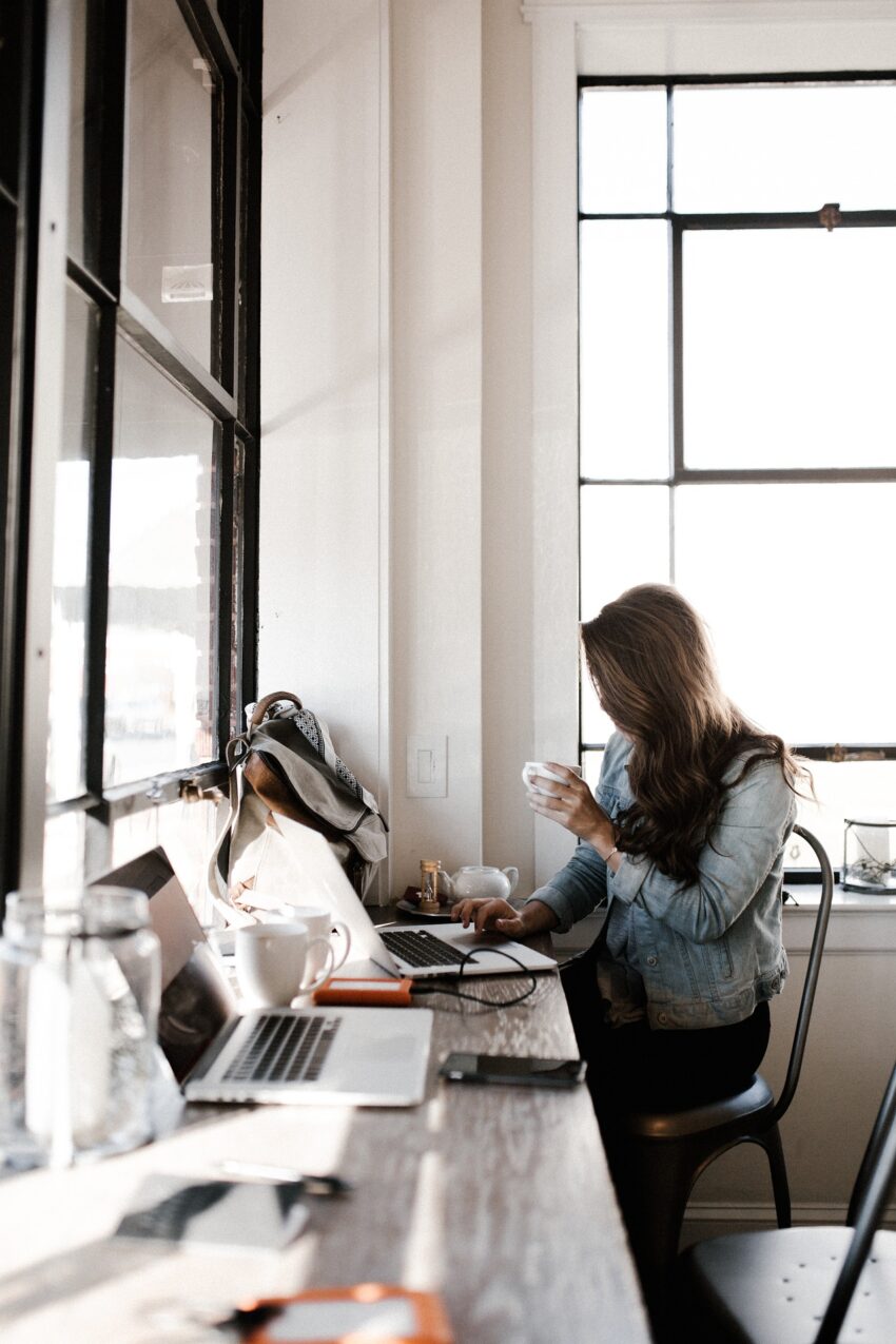 Woman holding caffe during work at her office workplace.