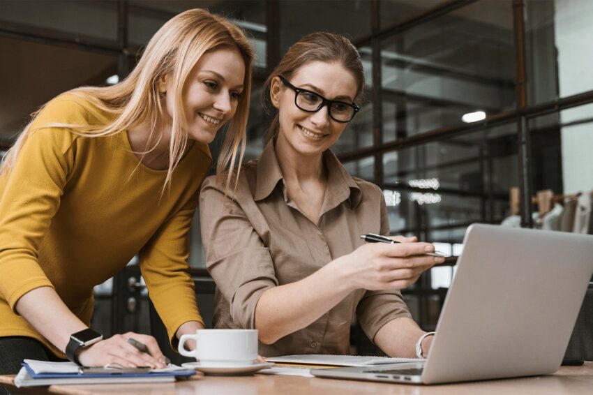 Two professional executives discussing financial accounting papers in office.